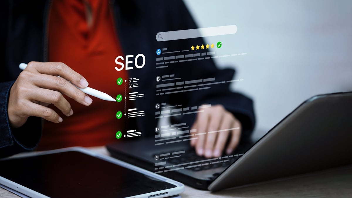 A business owner reviewing search visibility analytics on a laptop